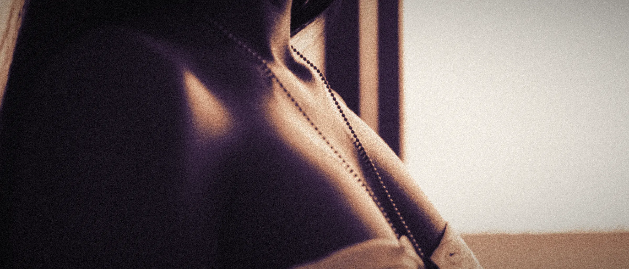 A bare shoulder and collarbone in soft window light